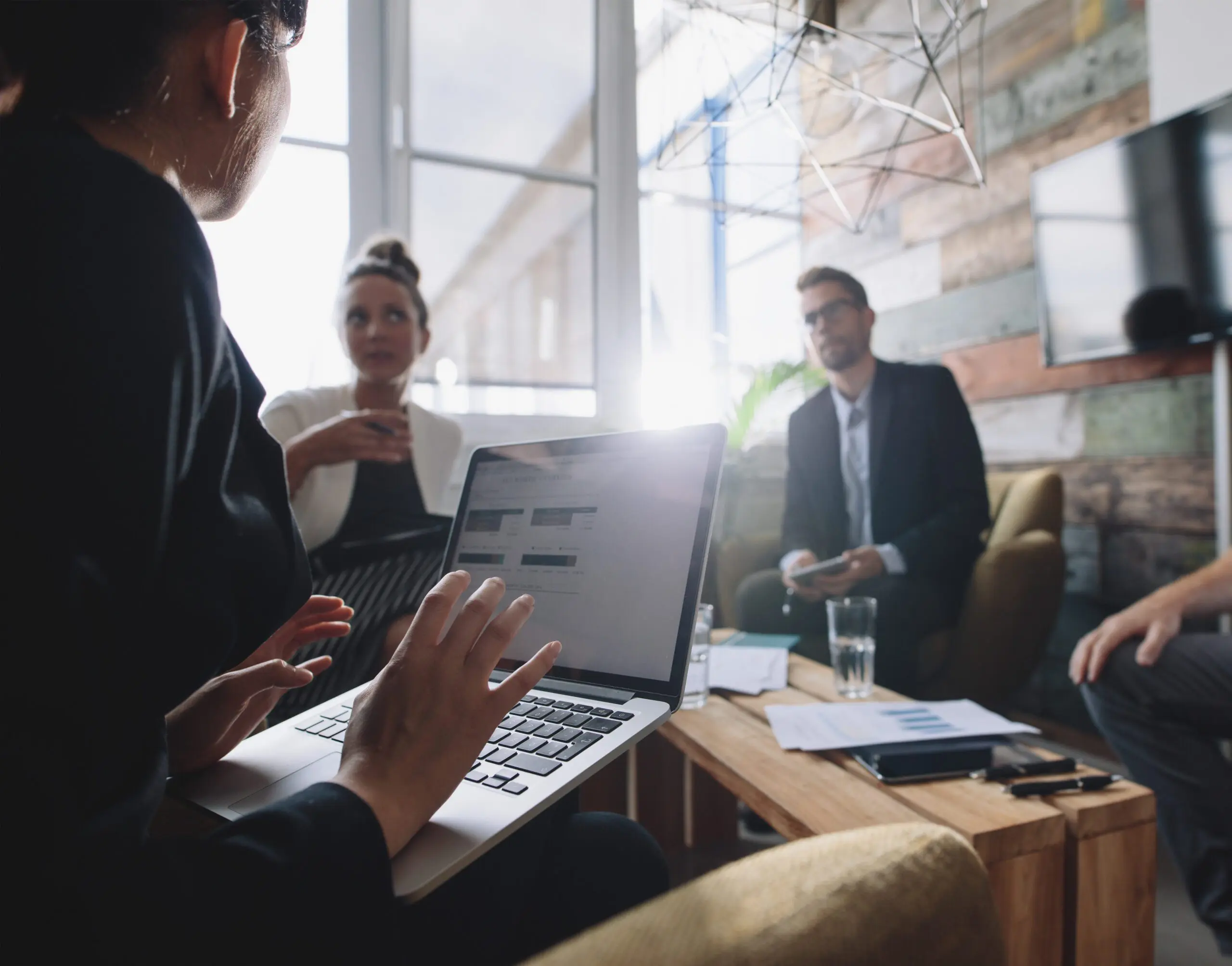 Woman in meeting talking to colleagues