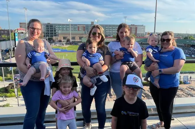 Harmony team with babies at a Cub's baseball game