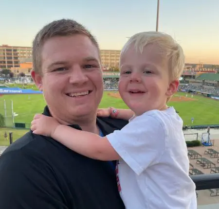 Scott with a child at a Cub's came