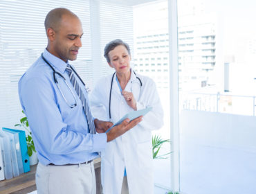 Medical Workers Looking at Tablet