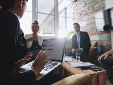 Woman in meeting talking to colleagues