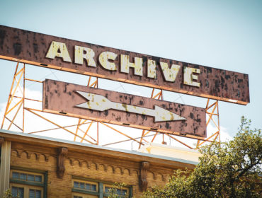 Street sign saying Archive pointing in a direction