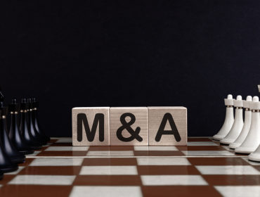 Chessboard With Wooden Blocks Showing Mergers And Acquisitions Concept