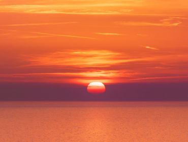 Sunset over the sea horizon nature landscape. Red clouds and sea landscape. Sea nature in sunset. Nature landscape. Sunset landscape background. Sunset over the sea landscape. Red sunset background. Landscape. Nature.