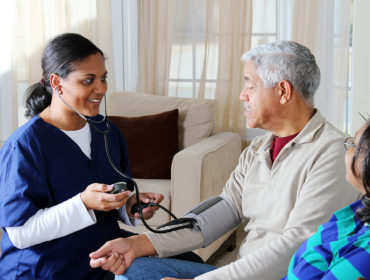 Home health care worker and an elderly couple