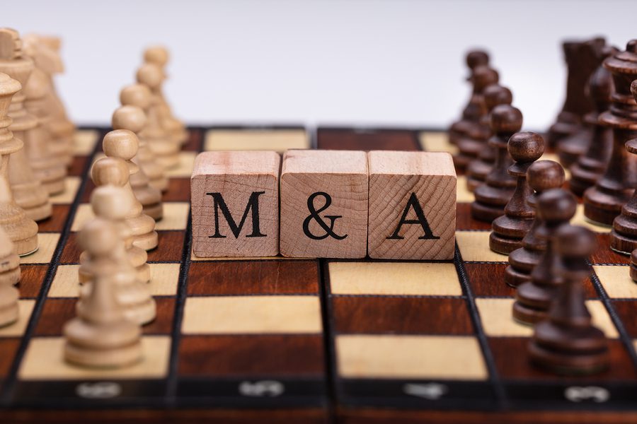 Chessboard With Wooden Blocks Showing Mergers And Acquisitions Concept