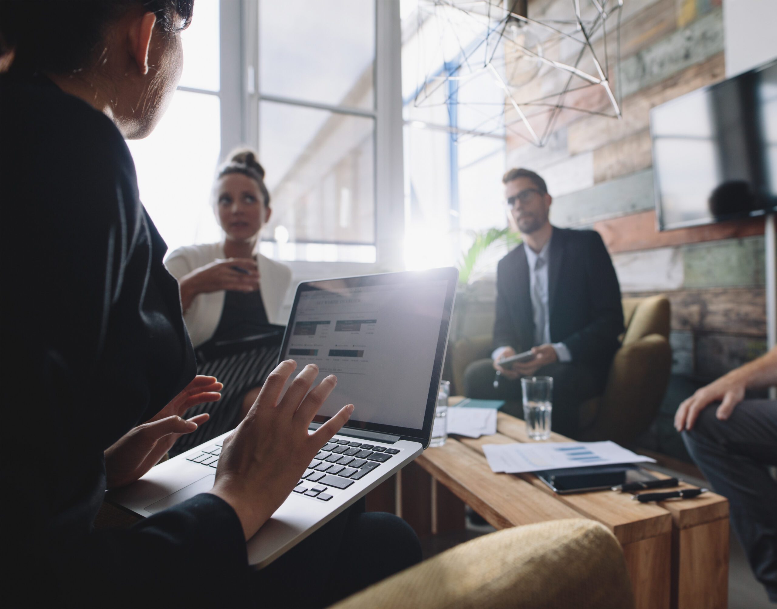 Woman in meeting talking to colleagues