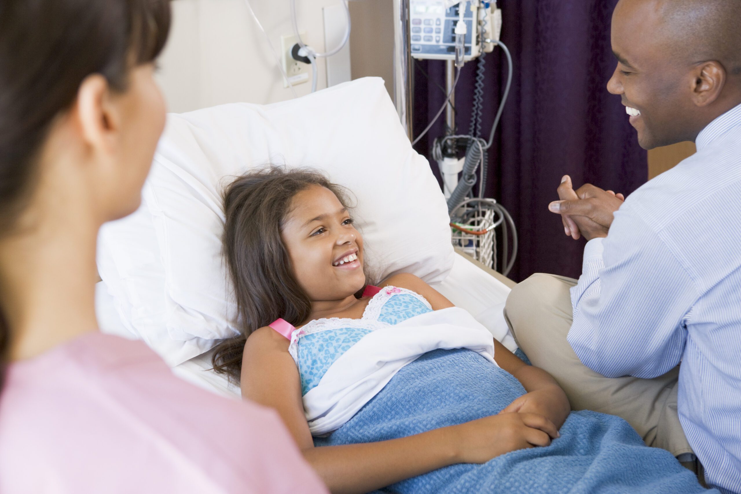 Doctor checking on child in hospital
